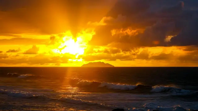 The sun setting over the sea